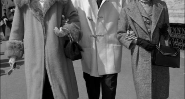 Jean Cocteau in short, white duffle coat with Coco Chanel & Miss Weiseveiller in Veneto Street, Rome 1958