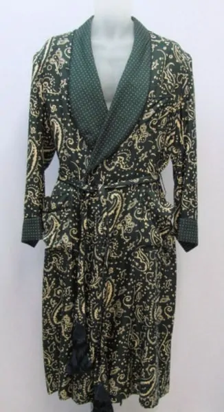 A photograph of a colorful green and gold dressing gown on a stand
