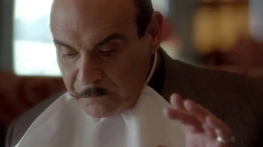 Poirot Eating with Napkin