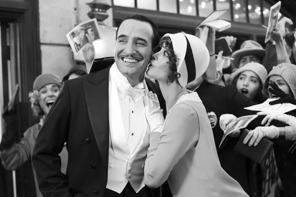 Jean Dujardin in White Tie being kissed by a woman - The Artist