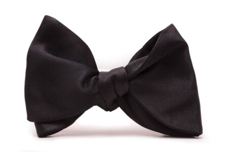 A large butterfly style black silk bow tie