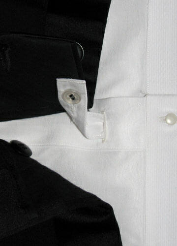 A tab below the bib buttons to the trouser waist to keep the shirt from pulling up.