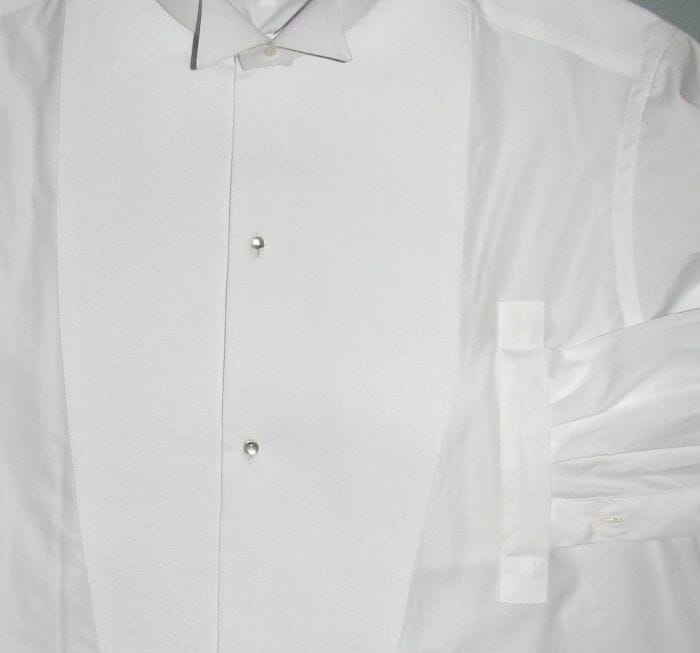 A side vent allows the wearer to slip one hand beneath the shirt to insert the studs without wrinkling the starched bib.
