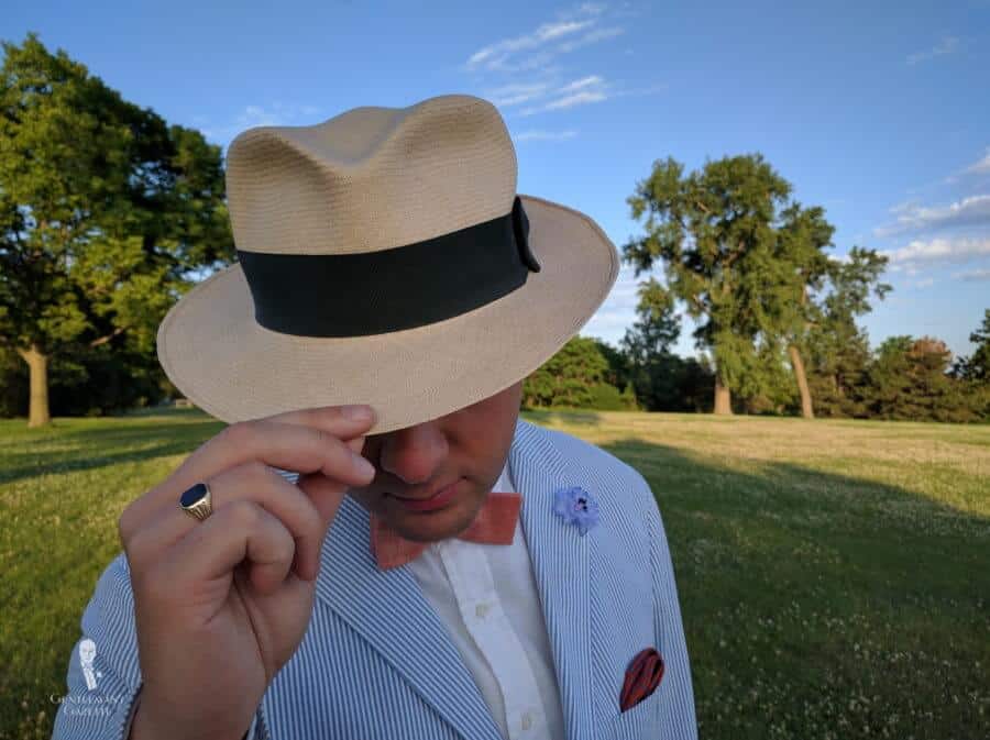Panama Hat with orange linen bow tie, cornflower boutonniere lapel pin and pocket square by Fort Belvedere