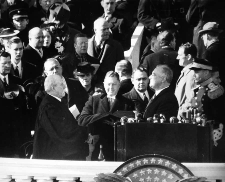 Chief Justice Charles Evans Hughes administering the oath of office to Franklin Delano Roosevelt on the east portico of the U.S. Capitol, January 20, 1941