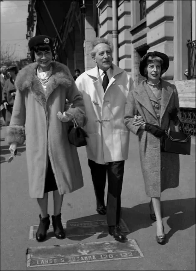 Jean Cocteau in short, white duffle coat with Coco Chanel & Miss Weiseveiller in Veneto Street, Rome 1958