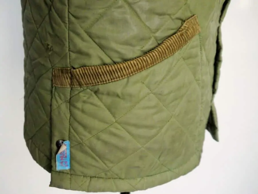Husky quilted jacket side view with angled patch pockets & side vents