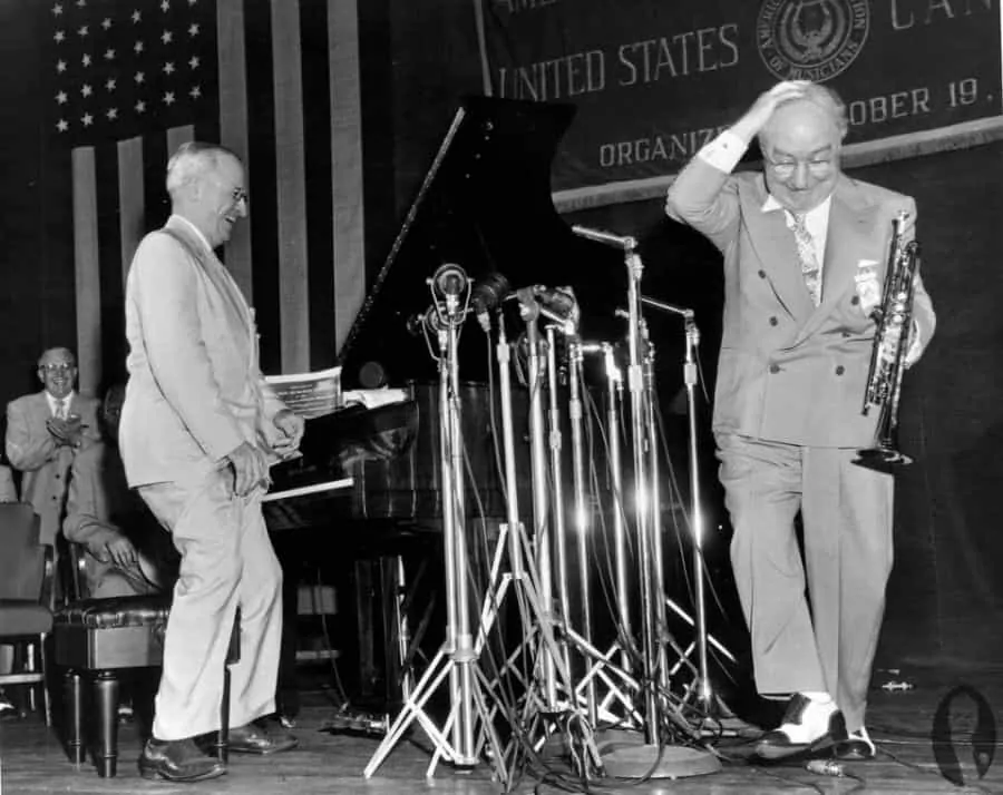 Truman in light colored suit and Oxford shoes