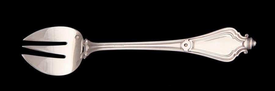 An Oyster Fork Will Rest On A Spoon To The Far Right On The Charger And Has Wider Tines Than A Seafood Fork. An oyster fork will rest on a spoon to the far right on the charger and has wider tines than a seafood fork.