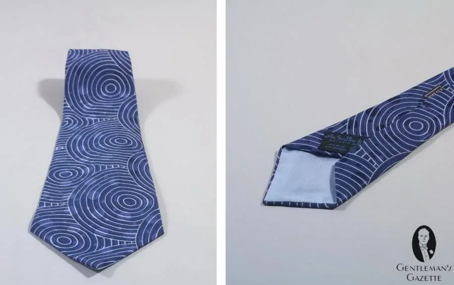 A Sulka Tie in Silk with circle and dots in blue, black & white