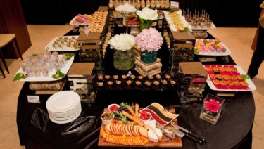 Buffet style food service with plates.