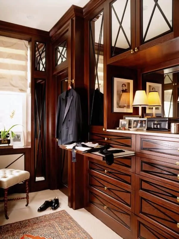 Classic closet with elegant woodwork and many drawers