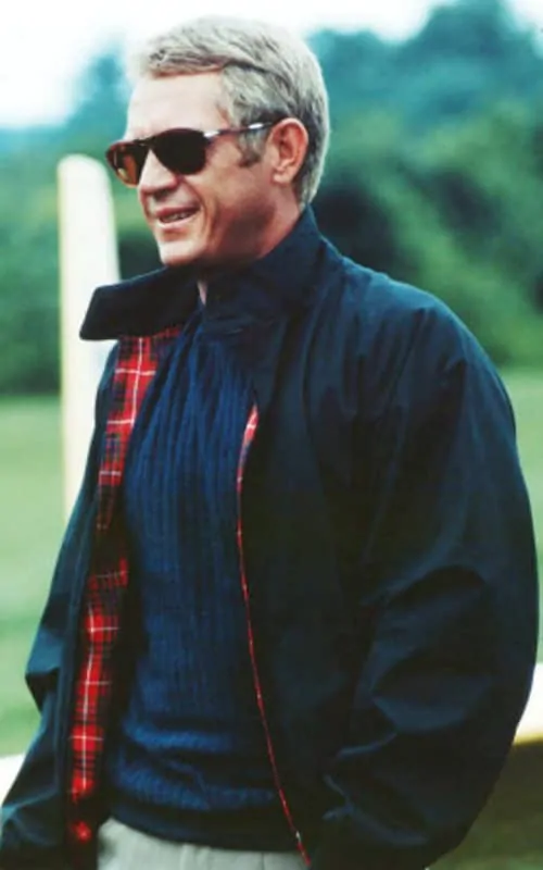 Steve McQueen wearing Persol sunglasses and a navy Harrington Jacket