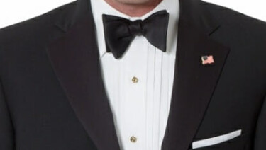 Brooks Brothers black tie outfit with an American flag pin in the lapel buttonhole