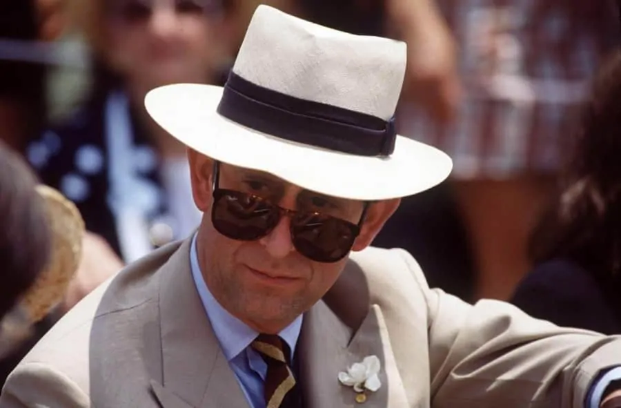Prince Charles in RayBan Sunglasses with Panama hat and Gardenia Boutonniere