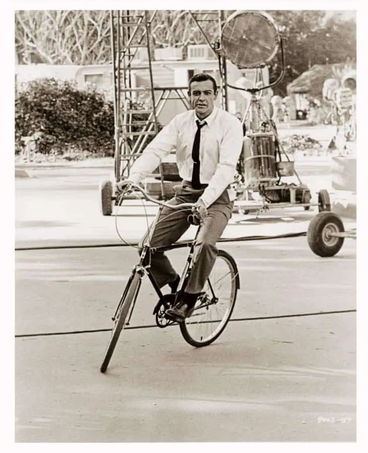 Sean Connery, casually on a bike with tie clip