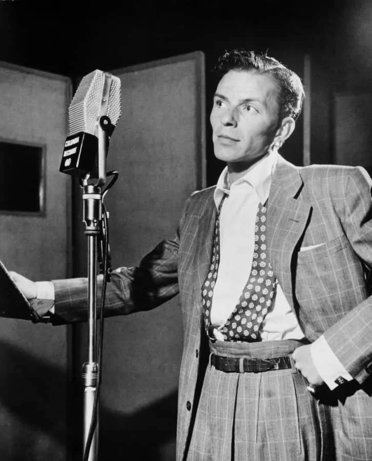 Frank Sinatra 1947 with windowpane suite and tucked in tie, and double pleats