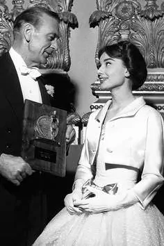 Audrey Hepburn and Gary Cooper in white tie, November 30, 1956, Paris.