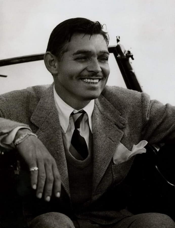 Clark Gable All Smiles In A Herringbone Jacket With V Neck Sweater And A Stripe Tie Clark Gable all smiles in a herringbone jacket with v-neck sweater and a stripe tie