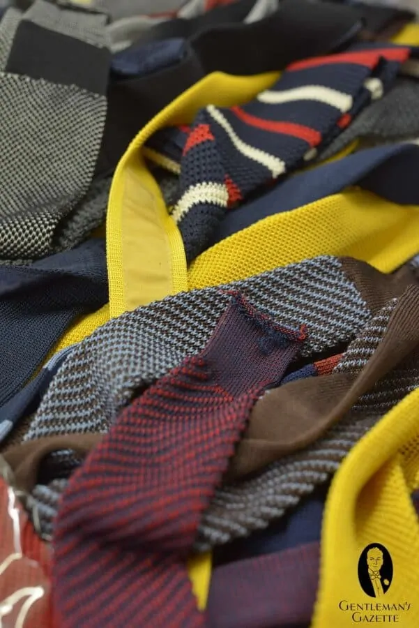 A number of different round knit, soft knit ties