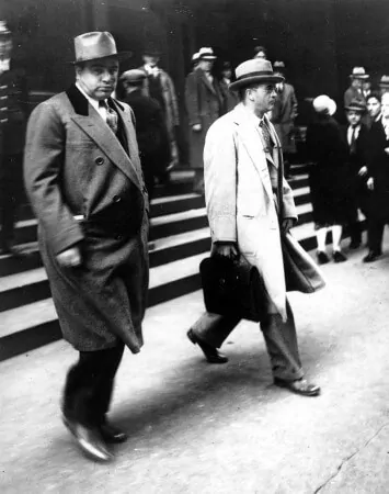 Capone being released from prison in 1939 with double breasted overcoat with cuffs and velvet collar