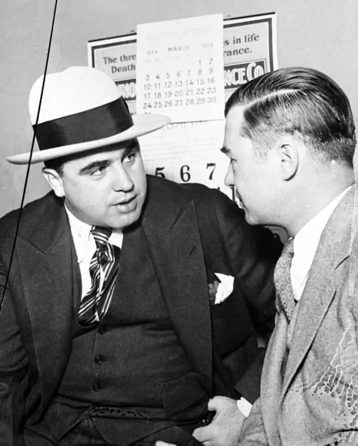 Capone in dark three piece suit with contrasting hat