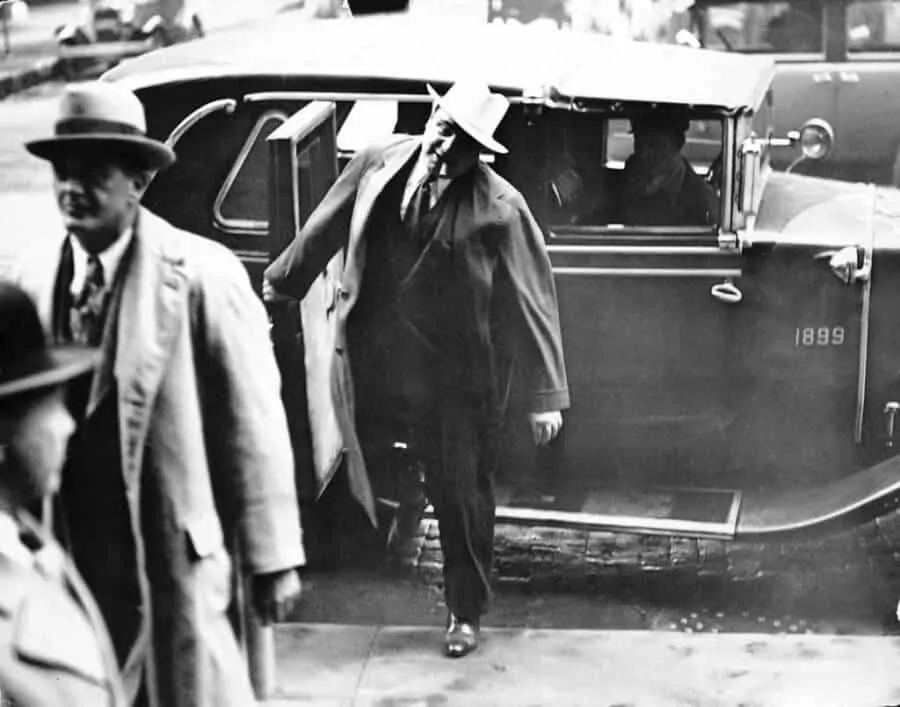 Capone wearing dark oxfords