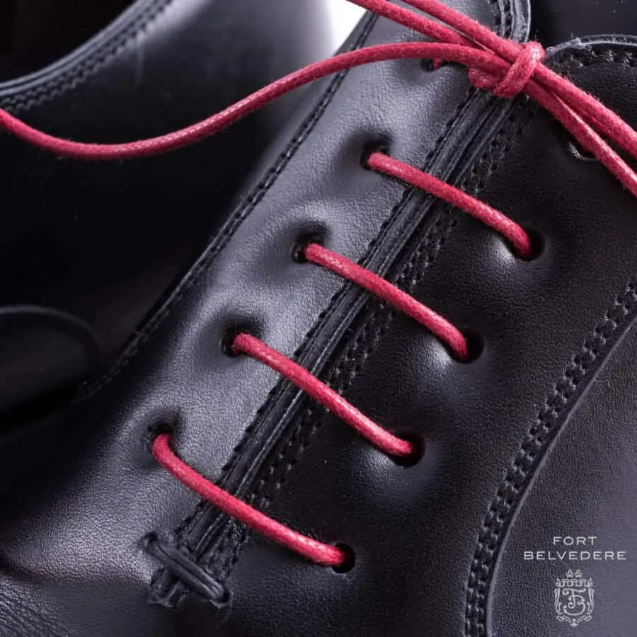 A close up shot of Red Shoelaces Round Waxed Cotton - Made in Italy by Fort Belvedere