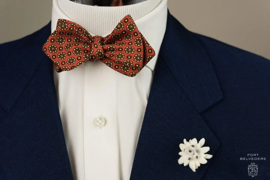 Ancient Madder Silk Bow Tie in Red & Buff Macclesfield Neats & Edelweiss Boutonniere - Fort Belvedere