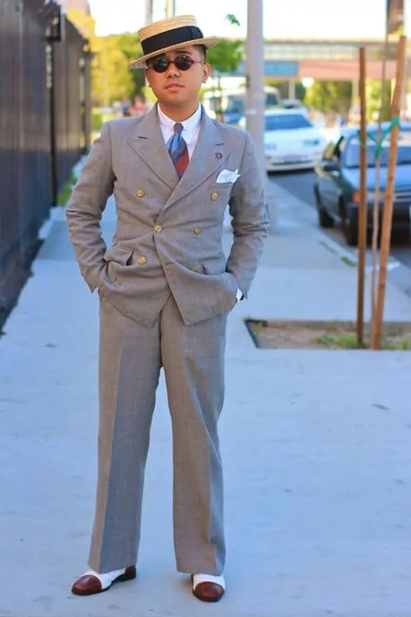 Ethan wearing is beloved spectators and a DB suit with faint mini windowpane paired with a boater hat