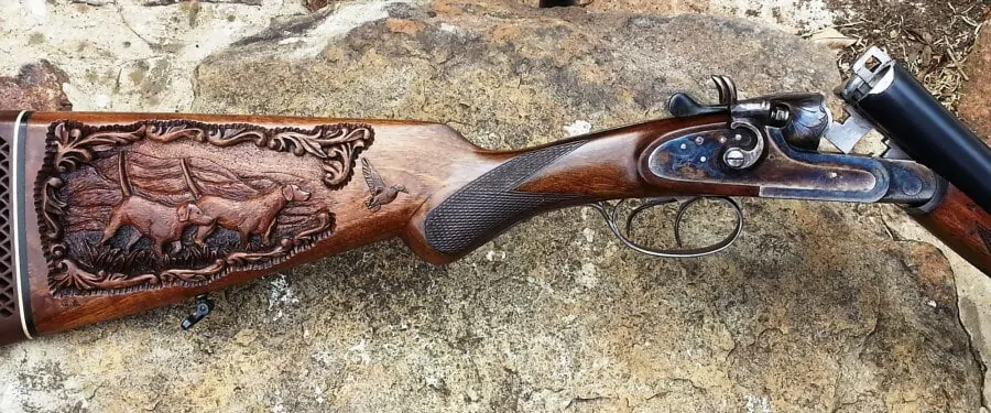 Hunting dog scene carved into this gun