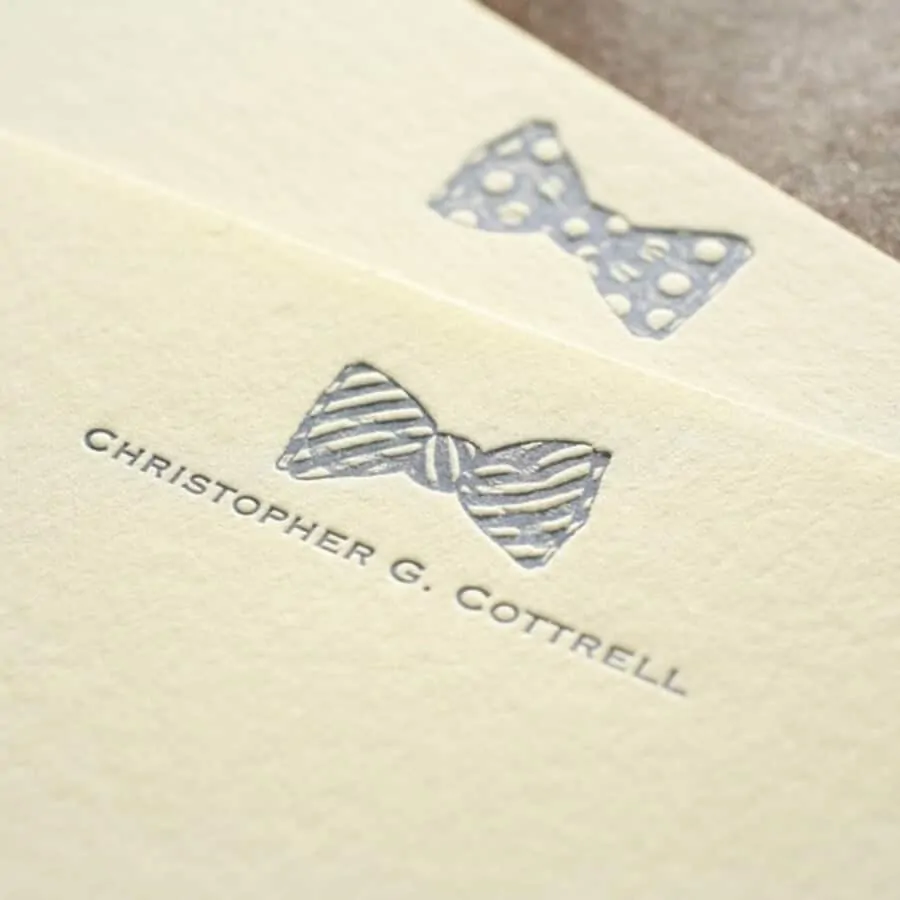 Modern letterpress stationery with a bow tie icon