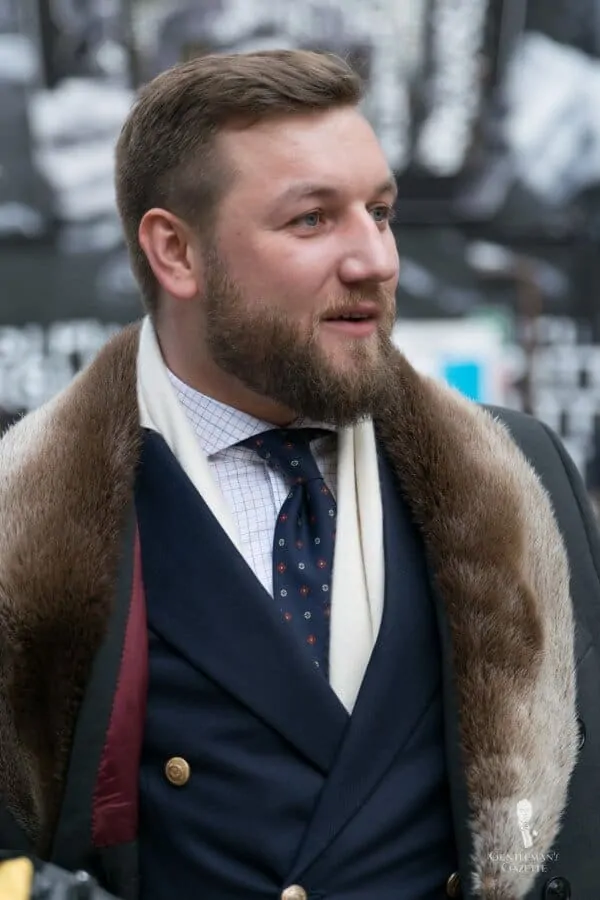 Tomasz Miler from Poland with blue blazer, fur collar, tattersall checked shirt and printed tie