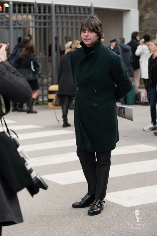 Valentino Ricci in dark green overcoat without a scarf