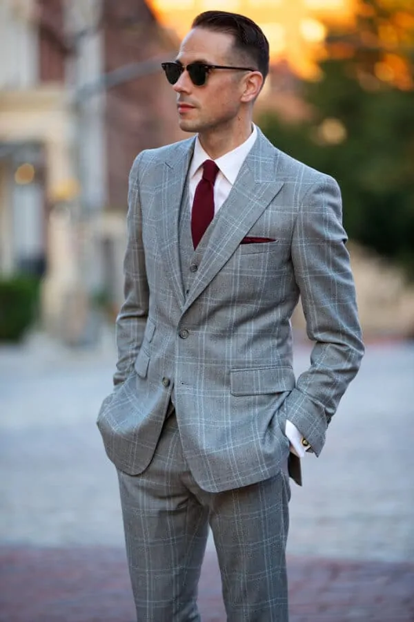 Brian Wearing A Grey Plaid Three Piece Suit with burgundy tie and pocket square - He Spoke Style