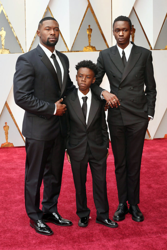 Trevante Rhodes, Alex R. Hibbert and Ashton Sanders in Calvin Klein tuxedos with flap pockets, and neckties paired with unusual shoes