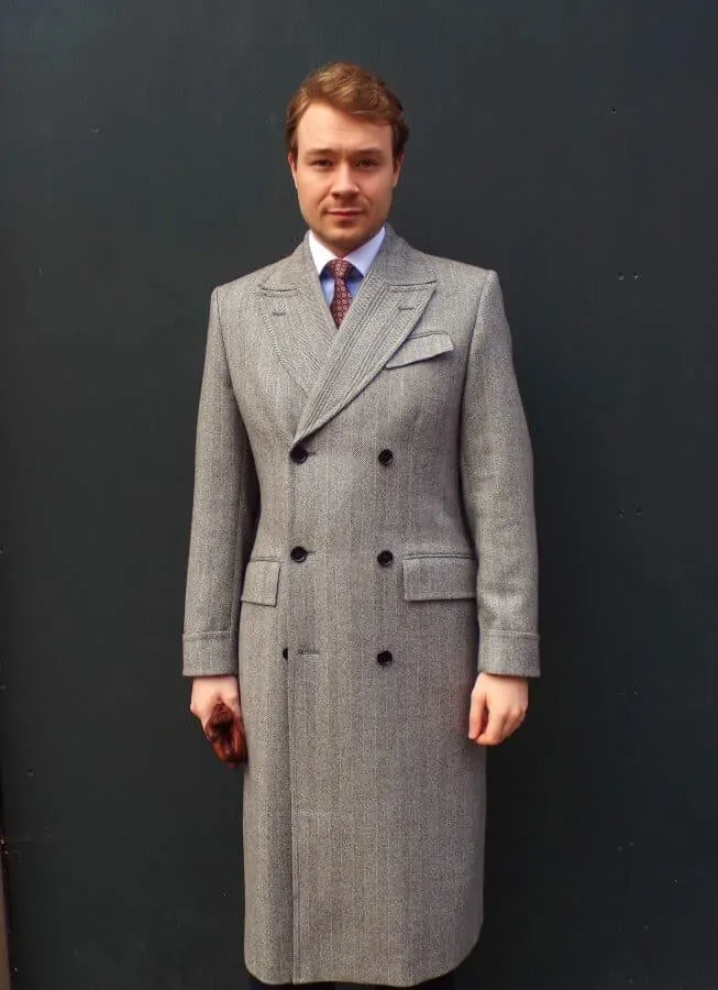 Aleks wearing a 6x3 herringbone overcoat with flapped chest pocket
