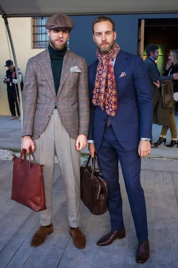 Andreas Weinas at Pitti Uomo in Florence wearing a trim blue suit with big printed scarf