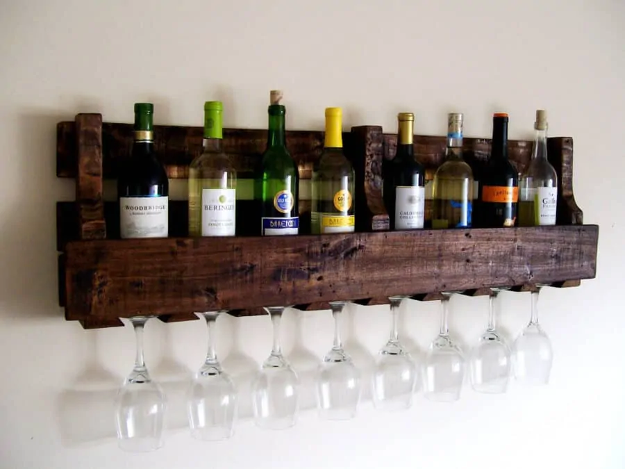 Reclaimed wood from pallets makes a rustic home bar shelf for wine and spirits