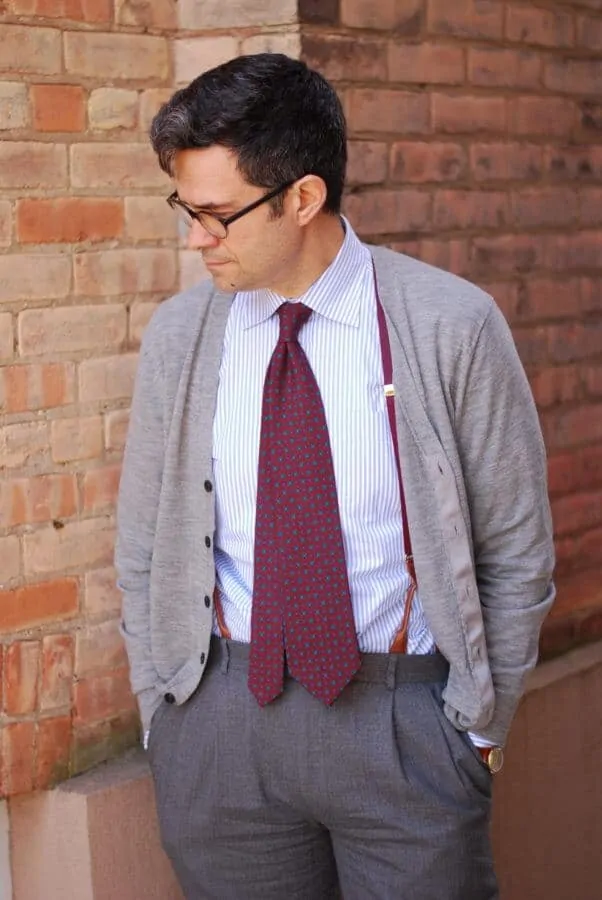 Madder inspired tie that extends beyond the waistband with suspenders, cardigan and vintage watch