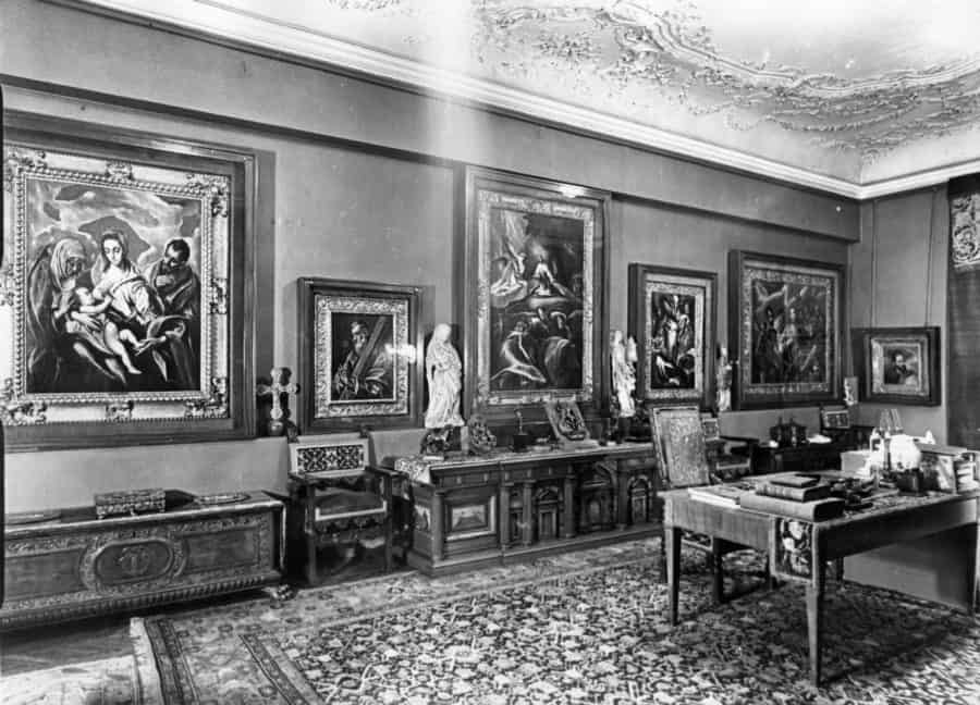 Home office with dark artworks by Goya and other artists