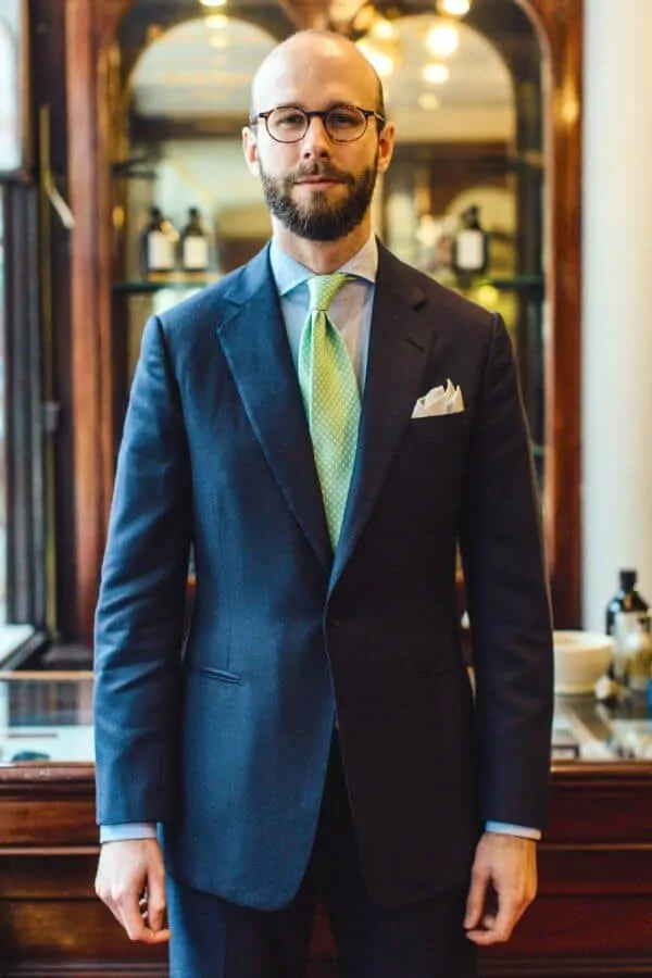 Simon in a simple single breasted solid suit with light green dotted tie
