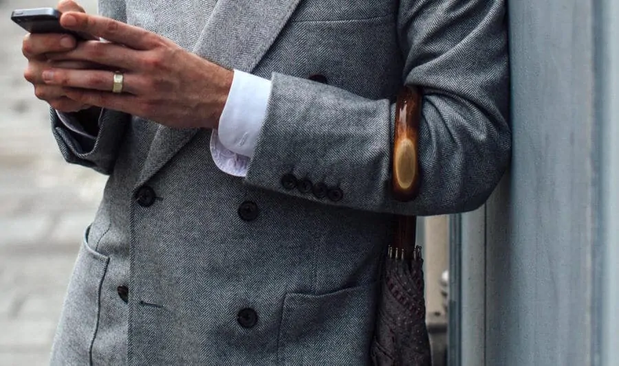 Simon with umbrella and unbuttoned barrel shirt cuffs
