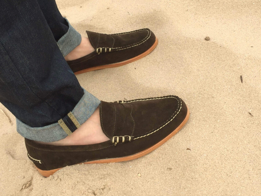 A pair of driving mocs worn on the beach