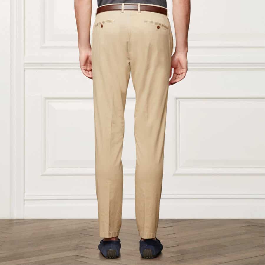 Classic Tan khakis with jetted back pocket with button and belt loops worn with driving mocs