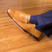 Tan single monk straps with navy pants and dark blue and royal blue shadow stripe socks