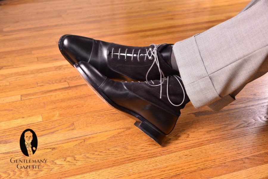 black balmoral boots with dark grey socks with houndstooth trousers