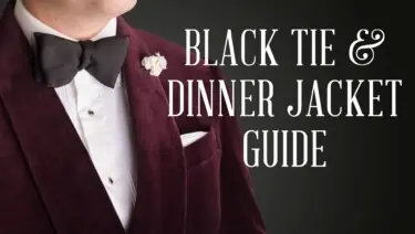 Raphael wearing a burgundy velvet dinner jacket, white shirt, black bow tie and white boutonniere and pocket square