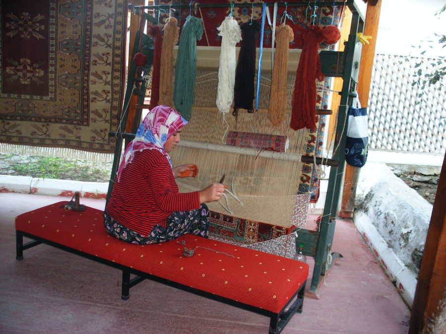 An artisan making an Oriental rug