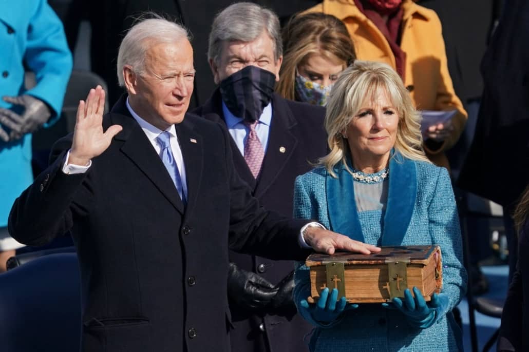Joe Biden wearing a navy single breasted overcoat
